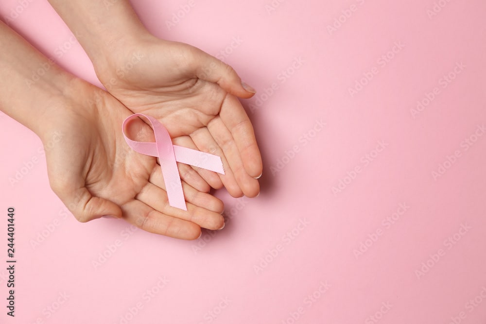 Free Stock Images to use for Website Hero Images:  Person Holding Pink Heart Ribbon